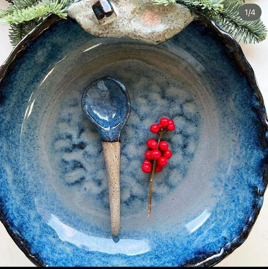 Handmade clay bowl with a matching spoon